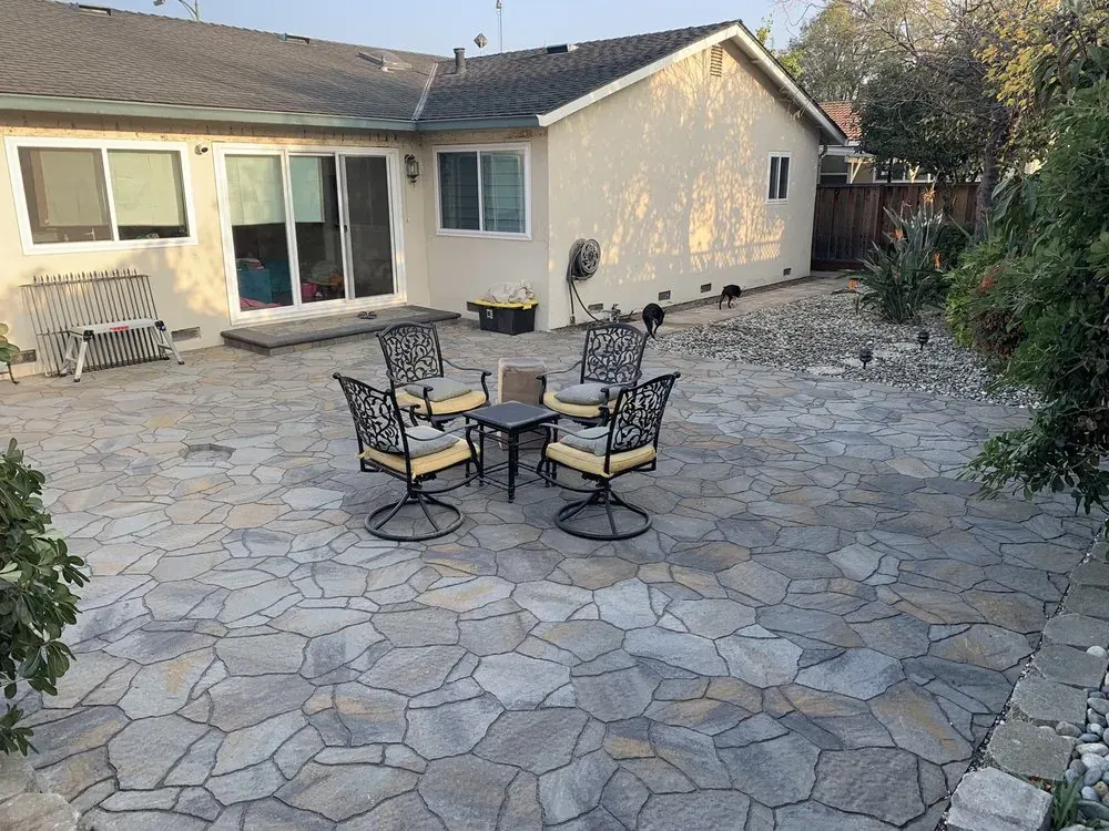 Flagstone patio with outdoor dining set in a San Jose backyard